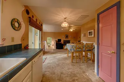 a kitchen with a table and a pink door at Suite Sunshine in Yosemite West