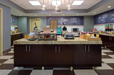 a kitchen with a counter in a store at Hampton Inn Visalia in Visalia