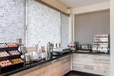 a restaurant with a counter with food on it at Days Inn & Suites by Wyndham Lodi in Lodi