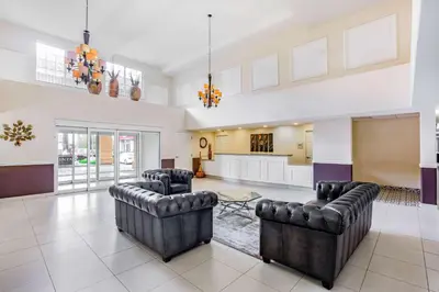 a large living room with two chairs and a table at La Quinta by Wyndham Fowler in Fowler