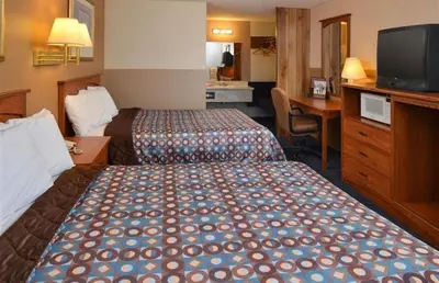 a hotel room with two beds and a desk at Americas Best Value Inn - Carson City in Carson City