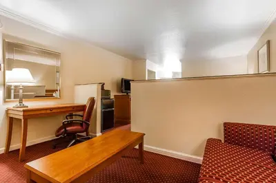 a room with a desk and a chair and a table at Quality Inn & Suites Gilroy in Gilroy