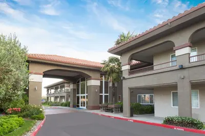 a view of a hotel building with a patio at Baymont by Wyndham Modesto Salida in Modesto