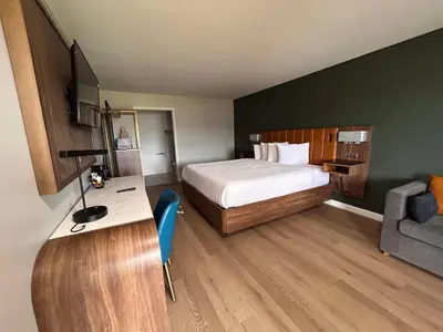 a hotel room with a bed and a desk and a chair at SureStay by Best Western Morgan Hill in Morgan Hill