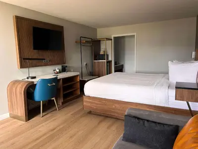 a hotel room with a bed and a desk with a computer at SureStay by Best Western Morgan Hill in Morgan Hill
