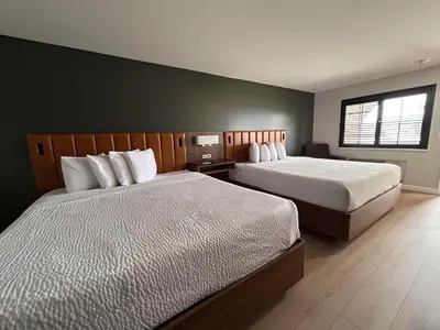 a bedroom with two beds and a window at SureStay by Best Western Morgan Hill in Morgan Hill