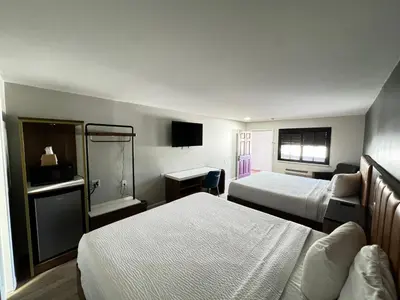 a hotel room with two beds and a television at SureStay by Best Western Morgan Hill in Morgan Hill