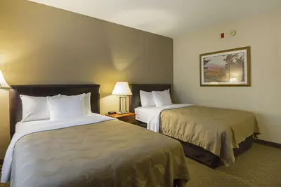 a hotel room with two beds in a room at Quality Inn Fresno Yosemite Airport in Fresno