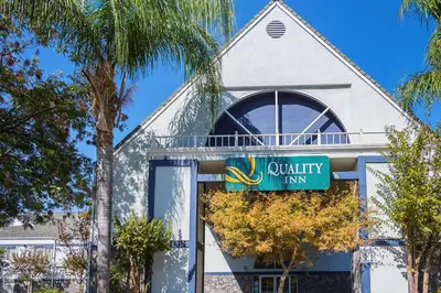 a building with a sign for a utility firm at Quality Inn Fresno Yosemite Airport in Fresno