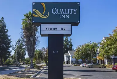 a sign for a university inn on a street at Quality Inn Fresno Yosemite Airport in Fresno