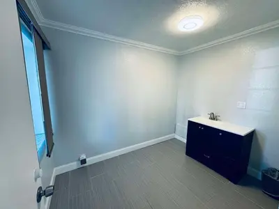 a bathroom with a sink in a room at SureStay by Best Western Fresno Central in Fresno