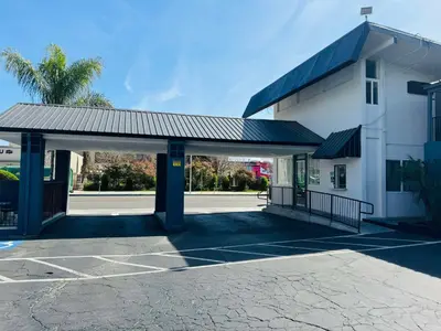 an empty parking lot in front of a building at SureStay by Best Western Fresno Central in Fresno