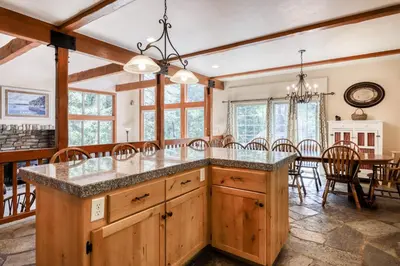 a kitchen with a large island and a dining room at Alderhill in Shaver Lake