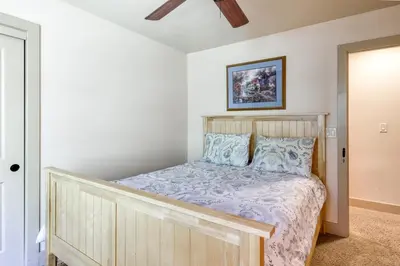 a bedroom with a wooden bed with blue pillows at Alderhill in Shaver Lake