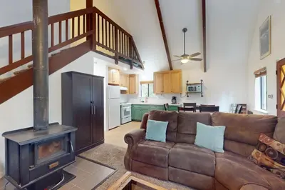 a living room with a couch and a wood stove at Deaver's Place in Shaver Lake