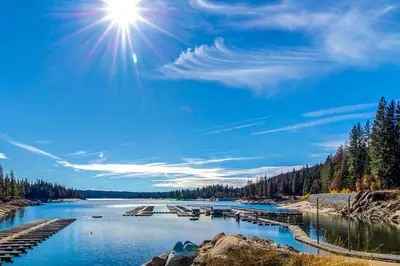 a view of a river with the sun in the sky at Eagle's Landing Condo 68 in Lakeshore