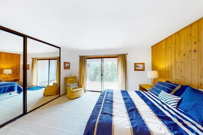 a bedroom with a large bed and a large mirror at Eagle's Landing Condo 78 in Lakeshore