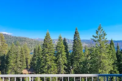 a view of a forest of trees from a balcony at Eagle's Landing Condo 78 in Lakeshore