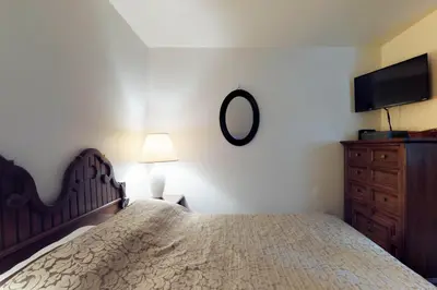 a bedroom with a bed and a dresser and a mirror at Foxtail Delight in Dora Belle