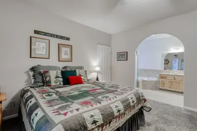 a bedroom with a bed and a bathroom at Hatcher's Hideaway in Shaver Lake