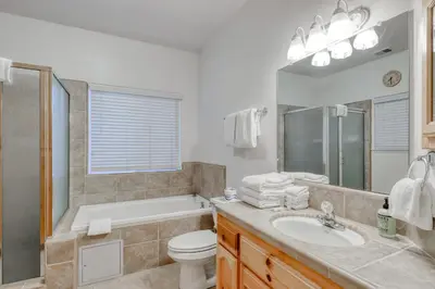 a bathroom with a tub and a sink and a toilet at Hatcher's Hideaway in Shaver Lake
