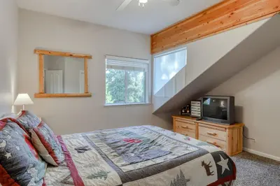 a bedroom with a bed and a television in it at Hatcher's Hideaway in Shaver Lake