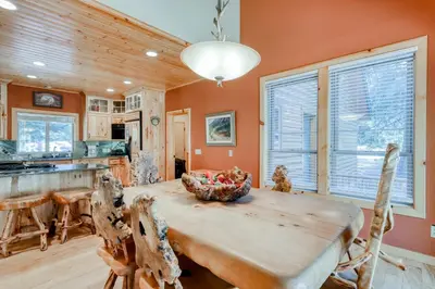 a kitchen and dining room with a wooden table and chairs at Pinnacle Point in Shaver Lake