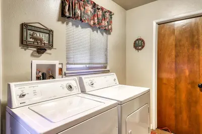 a washer and dryer in a laundry room with a window at The Limit in Dora Belle