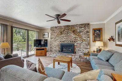 a living room with a couch and a fireplace at Water's Edge Retreat in Shaver Lake
