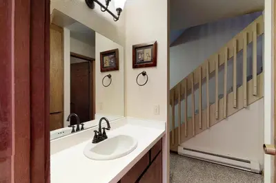 a bathroom with a sink and a mirror at Blue Jay Condominium in Lakeshore