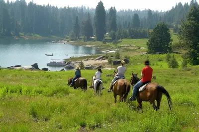 a group of people riding horses in a field at Blue Jay Condominium in Lakeshore