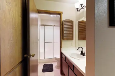 a bathroom with a sink and a shower at Blue Jay Condominium in Lakeshore