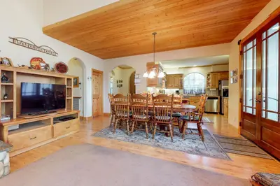a dining room and kitchen with a table and chairs at New England Cottage in Shaver Lake