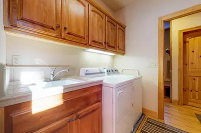 a kitchen with a sink and a dishwasher at New England Cottage in Shaver Lake