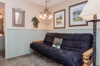 a living room with a black leather couch at Crestview -B # 46 in Mammoth Lakes