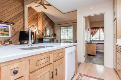 a kitchen with a sink and a living room at Crestview -B # 46 in Mammoth Lakes