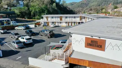 a building with cars parked in a parking lot at Historic Sonora Inn in Sonora