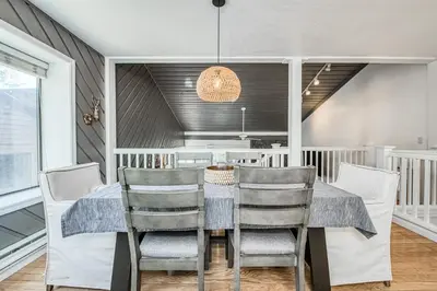 a dining room with a table and chairs at Huntington Lake Condo 115 in Lakeshore
