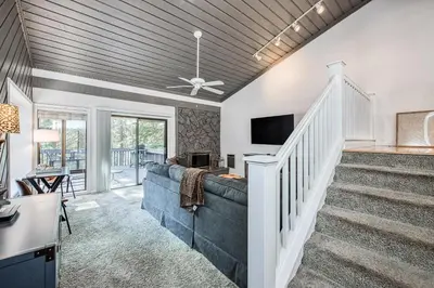 a living room with a couch and a tv at Huntington Lake Condo 115 in Lakeshore