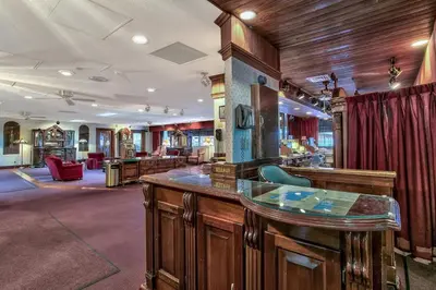 a bar in a barbershop with wooden walls and wood floors at Plaza Resort Club Reno in Reno