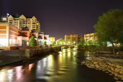 a river in a city at night with buildings at Plaza Resort Club Reno in Reno