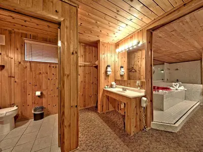 a wooden bathroom with a sink and a tub at Secrets Inn Lake Tahoe in South Lake Tahoe