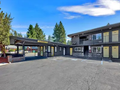 an empty parking lot in front of a building at Secrets Inn Lake Tahoe in South Lake Tahoe