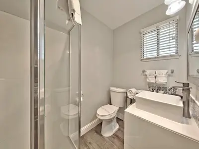 a white bathroom with a toilet and a sink at Heavenly Inn Lake Tahoe in South Lake Tahoe