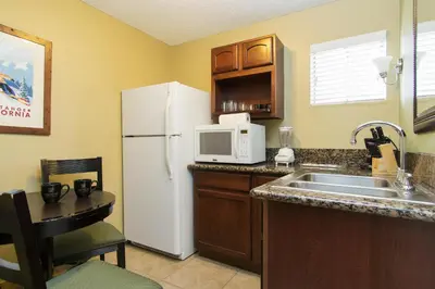 a kitchen with a white refrigerator and a sink at Heavenly Inn Lake Tahoe in South Lake Tahoe