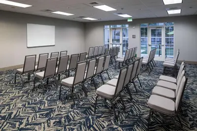 a conference room with chairs and a whiteboard at Homewood Suites by Hilton Fresno Airport/Clovis in Clovis