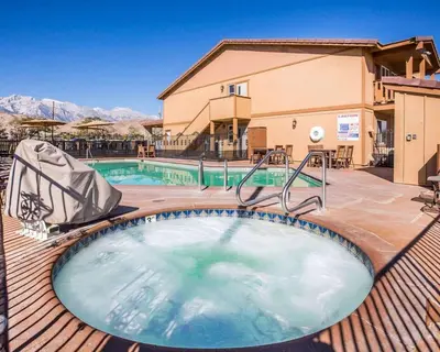 a hot tub on a deck next to a building at Quality Inn Lone Pine near Mount Whitney in Lone Pine