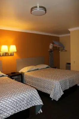 a hotel room with two beds and two lamps at Timberline Motel in Lone Pine