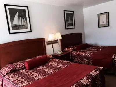 a hotel room with two beds in a room at Maple Inn and Suites Los Banos in Los Banos