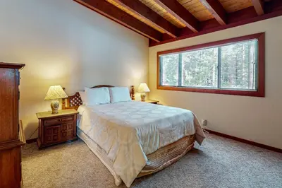 a bedroom with a large bed and a window at Tahoe City Retreat in Lake Forest